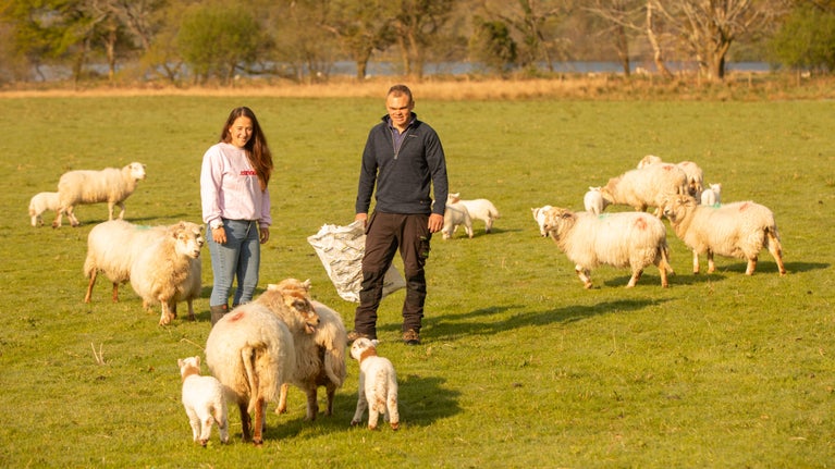 Sara Jenkins and Ioan Jones, winners of Our Dream Farm with Matt Baker, with sheep on their farm in Eryri